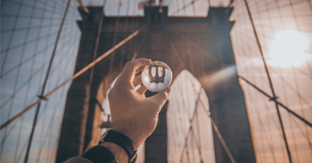 Glass ball is held up to the Golden Gate Bridge