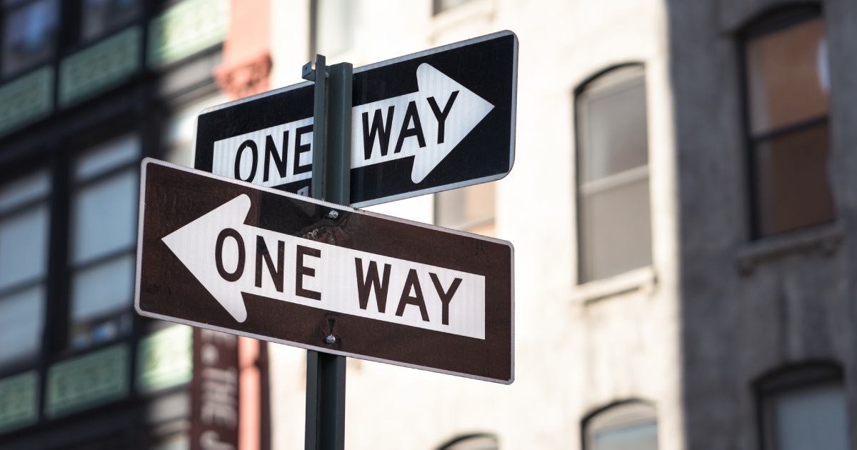 crossed One-Way signs on New York city street